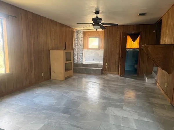 an empty room with windows and closet