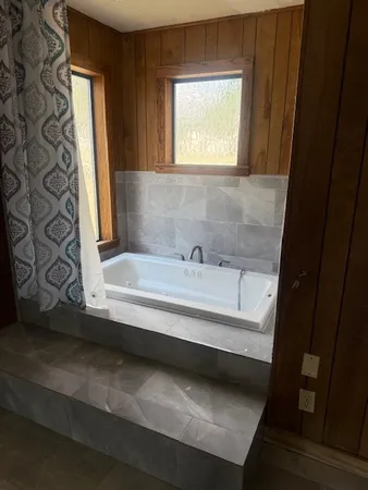 a bathroom with a bathtub and a shower