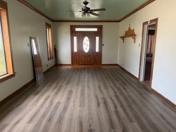 wooden floor in an empty room with a window