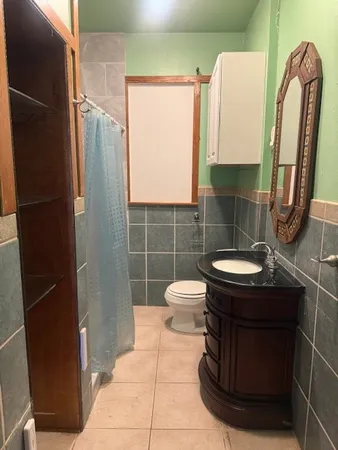 a bathroom with a sink a toilet and a mirror