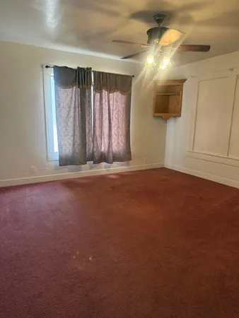 a view of wooden floor and window in a room