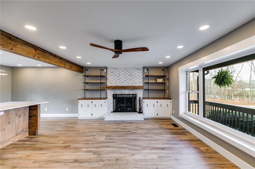 118 Raven Road Villa Rica, GA 30180 - Photo 15 of 50 a large living room with a fireplace and a ceiling fan