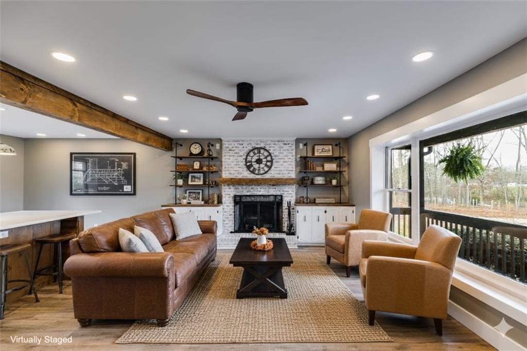 118 Raven Road Villa Rica, GA 30180 - Photo 16 of 50 a living room with furniture a fireplace and a large window