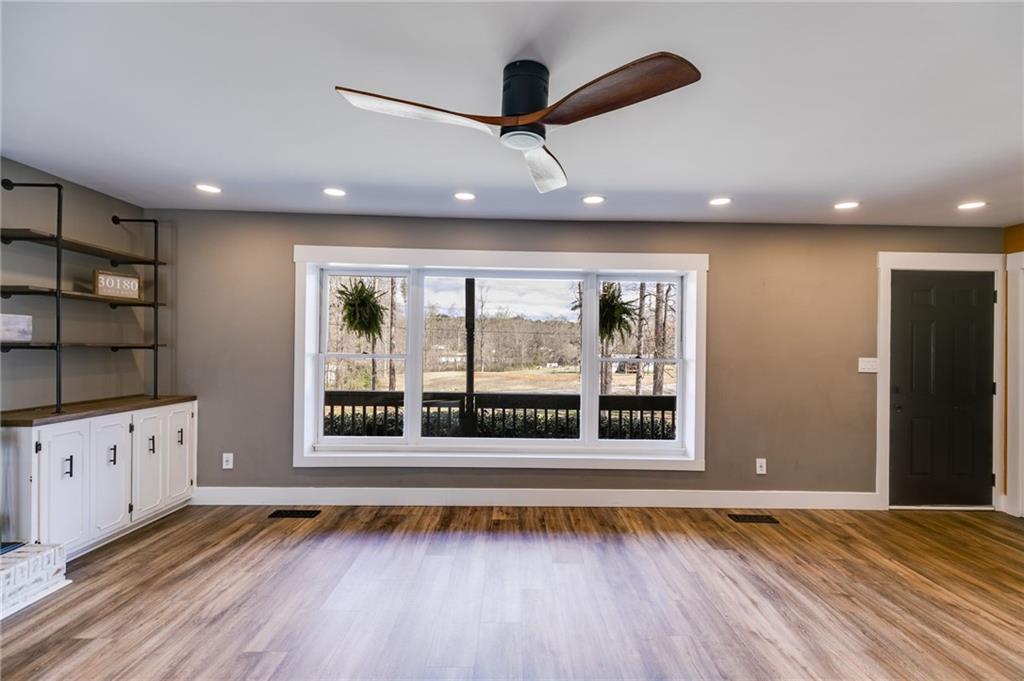 118 Raven Road Villa Rica, GA 30180 - Photo 19 of 50 a view of an empty room with wooden floor and a window