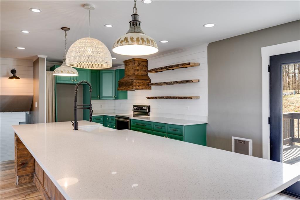 118 Raven Road Villa Rica, GA 30180 - Photo 22 of 50 a large white kitchen with a large island oven a stove and a sink