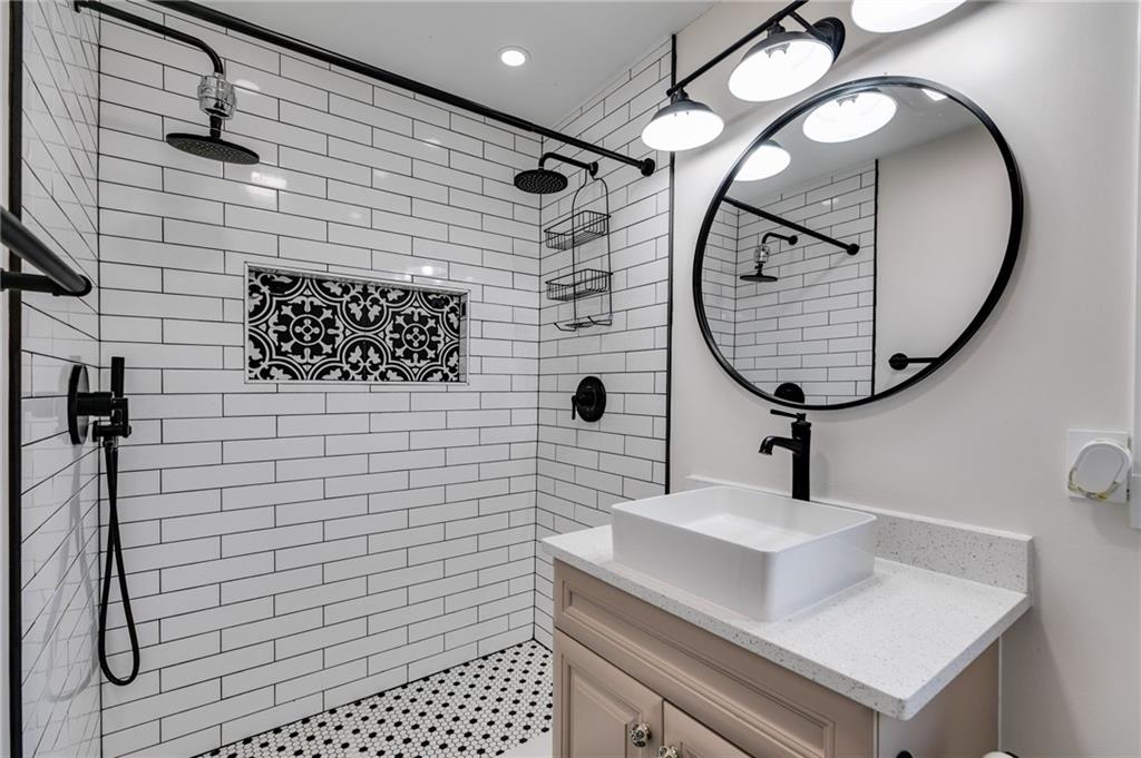 118 Raven Road Villa Rica, GA 30180 - Photo 32 of 50 a bathroom with a sink toilet a mirror and tub