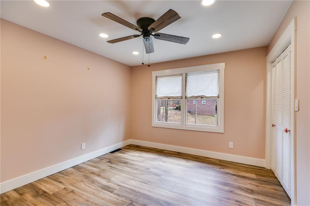 118 Raven Road Villa Rica, GA 30180 - Photo 39 of 50 an empty room with wooden floor and windows