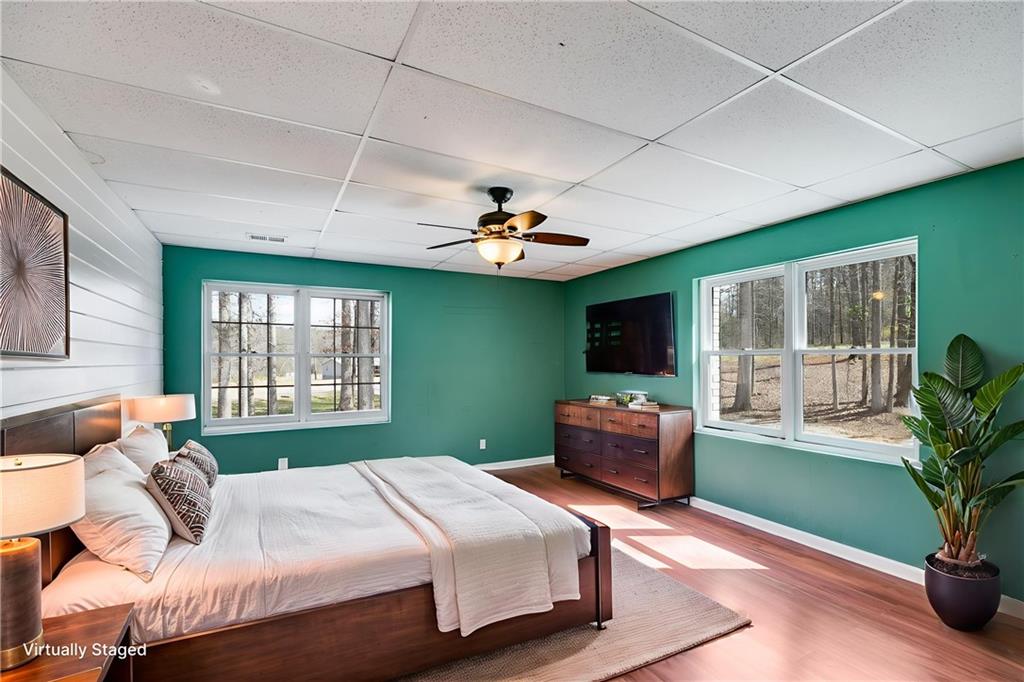 118 Raven Road Villa Rica, GA 30180 - Photo 40 of 50 a bedroom with a large bed and a chandelier