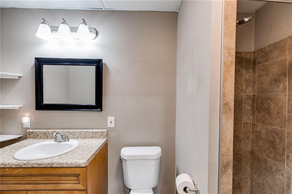 118 Raven Road Villa Rica, GA 30180 - Photo 46 of 50 a bathroom with a toilet sink and mirror