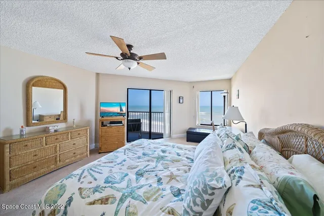 a bedroom with a bed and a dresser with mirror