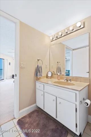 a bathroom with a granite countertop sink mirror and