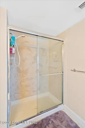 a bathroom with a glass shower door