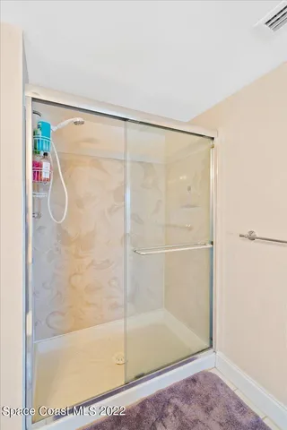 a bathroom with a glass shower door