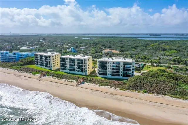 a view of a garden with a building in the background