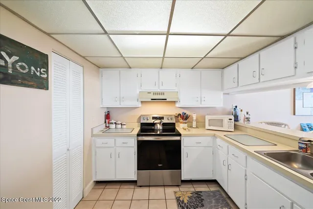 a kitchen with cabinets appliances and a sink