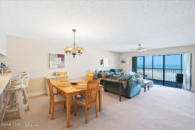 a living room with furniture a ceiling fan and a window
