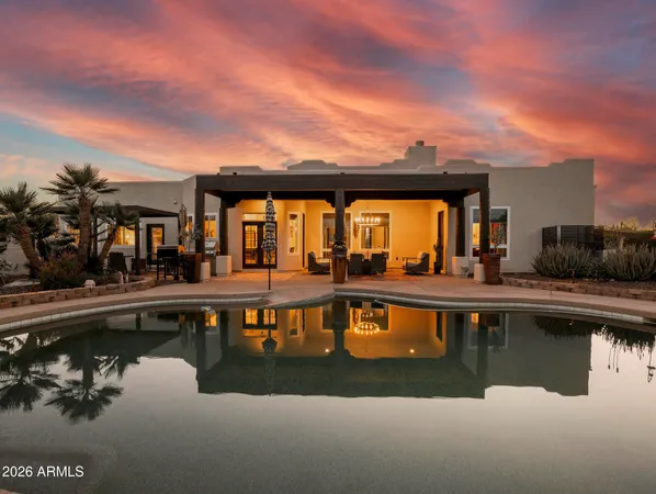 a view of a swimming pool with outdoor seating