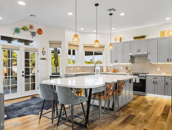 a kitchen with a table chairs sink and cabinets