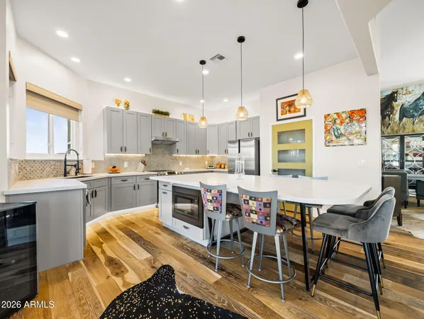 a large kitchen with kitchen island a counter space a sink appliances and cabinets