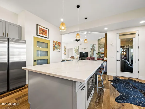 a kitchen with stainless steel appliances granite countertop a sink a stove top oven a counter space and cabinets