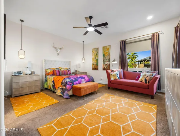 a bedroom with a bed and a chandelier