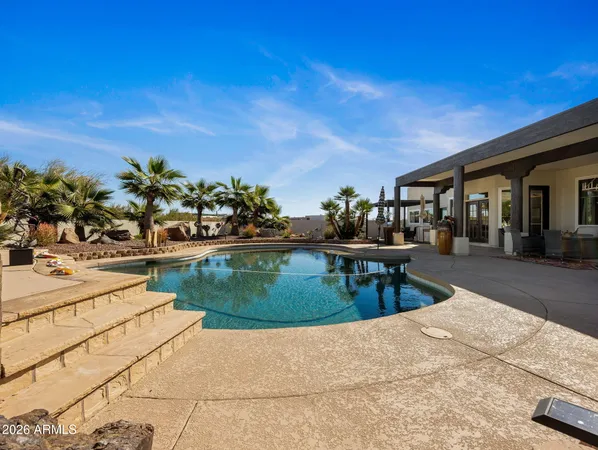 a view of a roof deck with chair and tables
