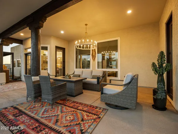 a living room with furniture a chandelier and a dining table