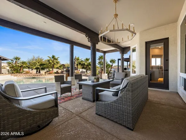 a view of a patio with dining table and chairs