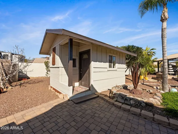 a view of a dry yard with a house