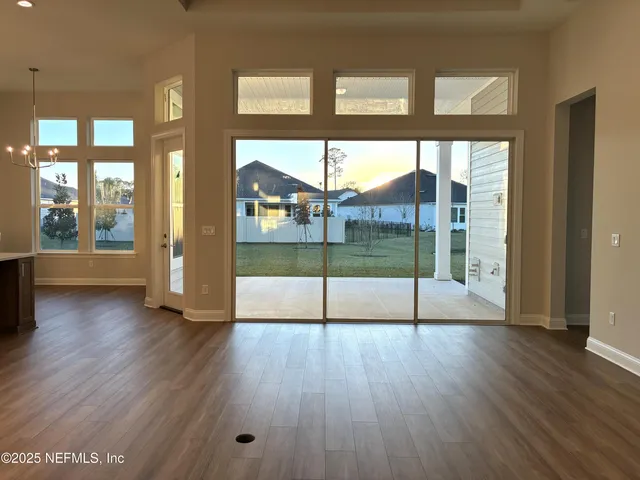 a open kitchen with stainless steel appliances granite countertop a sink dishwasher a stove and a refrigerator with wooden floor