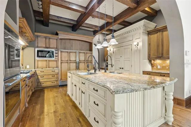 a bathroom with a granite countertop sink a large mirror and vanity