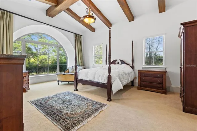 a living room with fireplace furniture and a large window