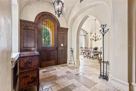 a view of living room and hallway with wooden floor