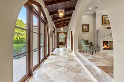 a view of a hallway with furniture and a fireplace