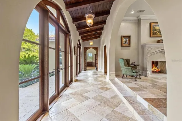 a view of a hallway with furniture and a fireplace