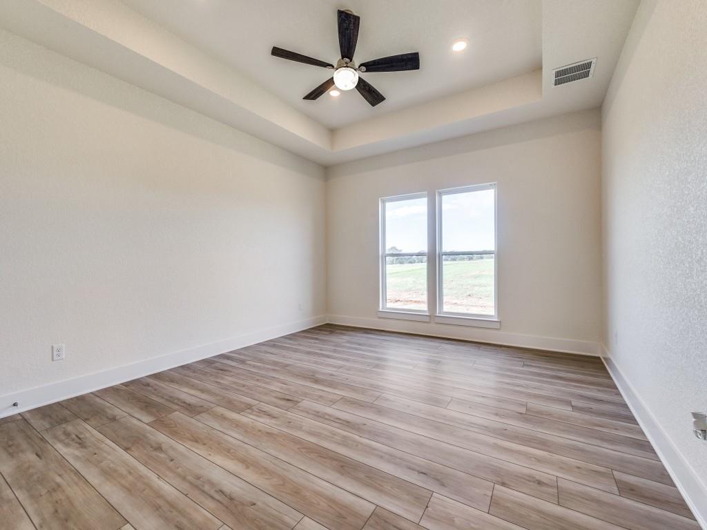 300 County Road 3141 Decatur, TX 76234 - Photo 12 of 25 wooden floor in an empty room with a window