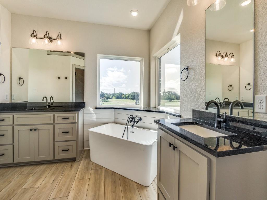 300 County Road 3141 Decatur, TX 76234 - Photo 13 of 25 a bathroom with a sink double vanity granite and a large mirror