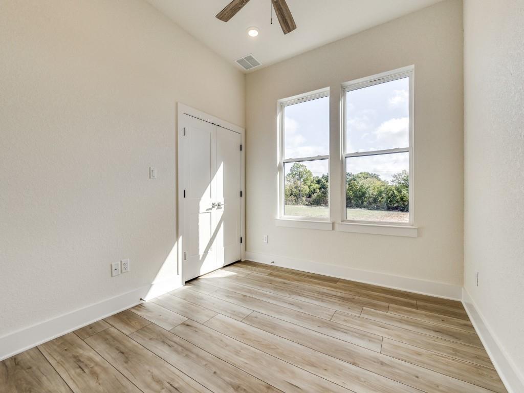 300 County Road 3141 Decatur, TX 76234 - Photo 16 of 25 an empty room with wooden floor and windows