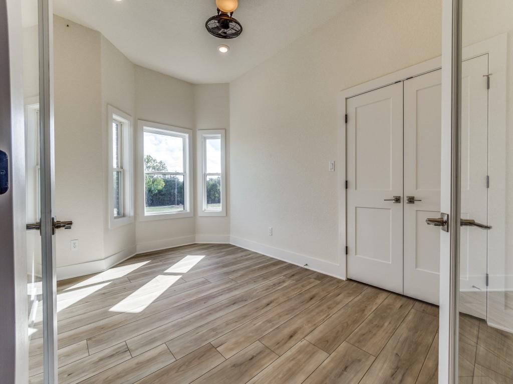 300 County Road 3141 Decatur, TX 76234 - Photo 6 of 25 wooden floor in an empty room with a window