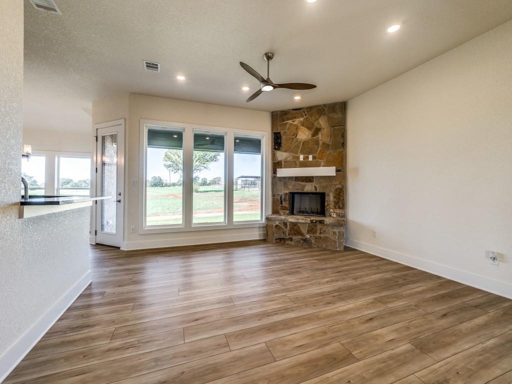 300 County Road 3141 Decatur, TX 76234 - Photo 7 of 25 a view of empty room with wooden floor and fireplace