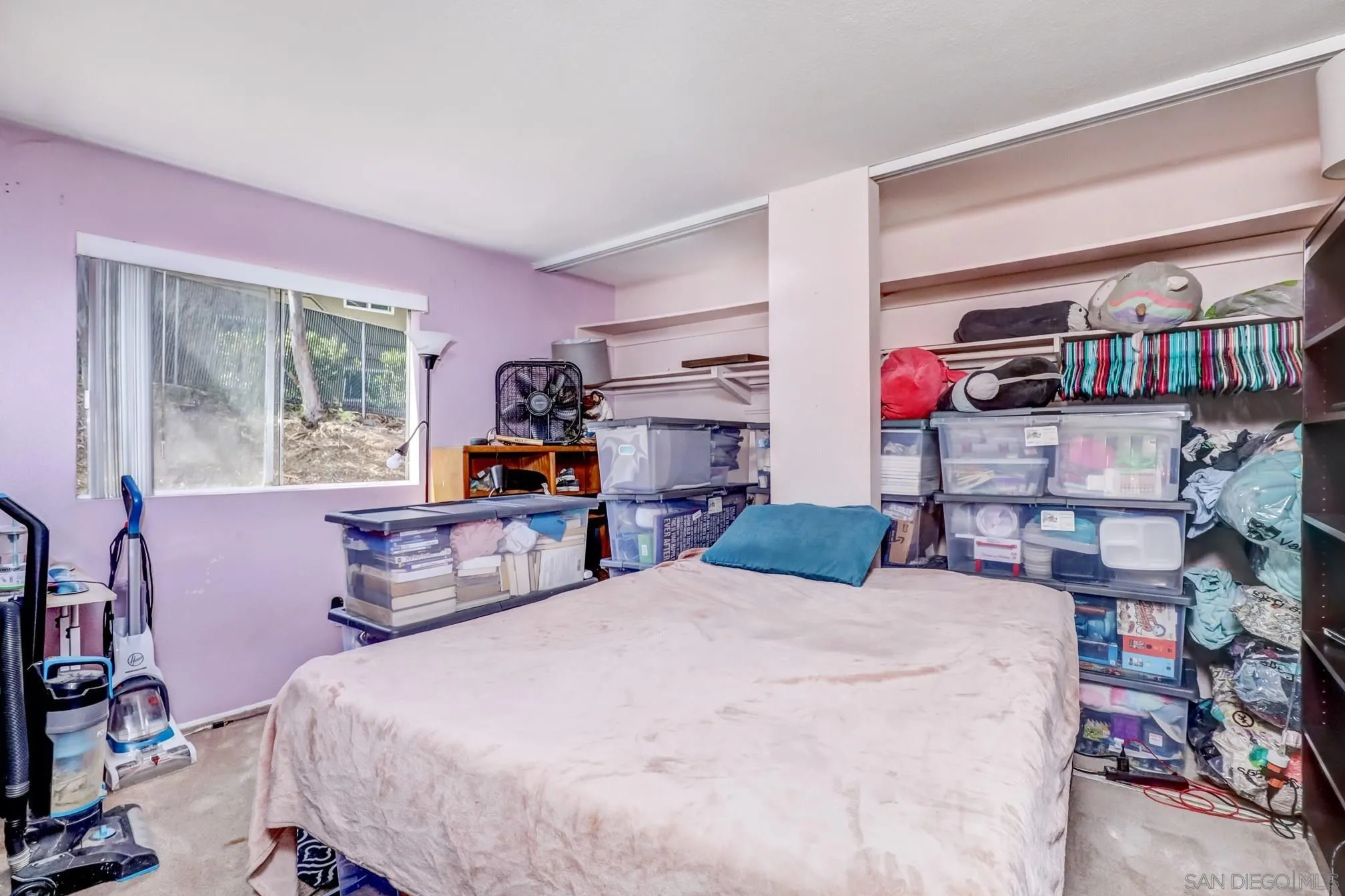 3557 Kenora Drive, Unit 17 Spring Valley, CA 91977 - Photo 2 of 8 a bedroom with a bed a dresser and a book shelf