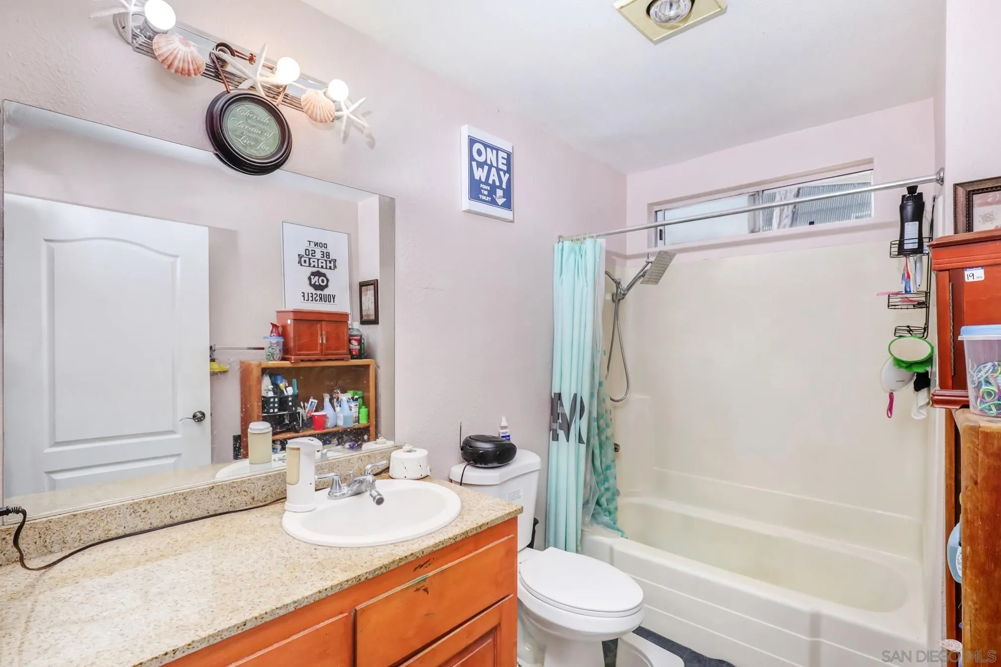 3557 Kenora Drive, Unit 17 Spring Valley, CA 91977 - Photo 3 of 8 a bathroom with a sink vanity mirror bathtub and toilet
