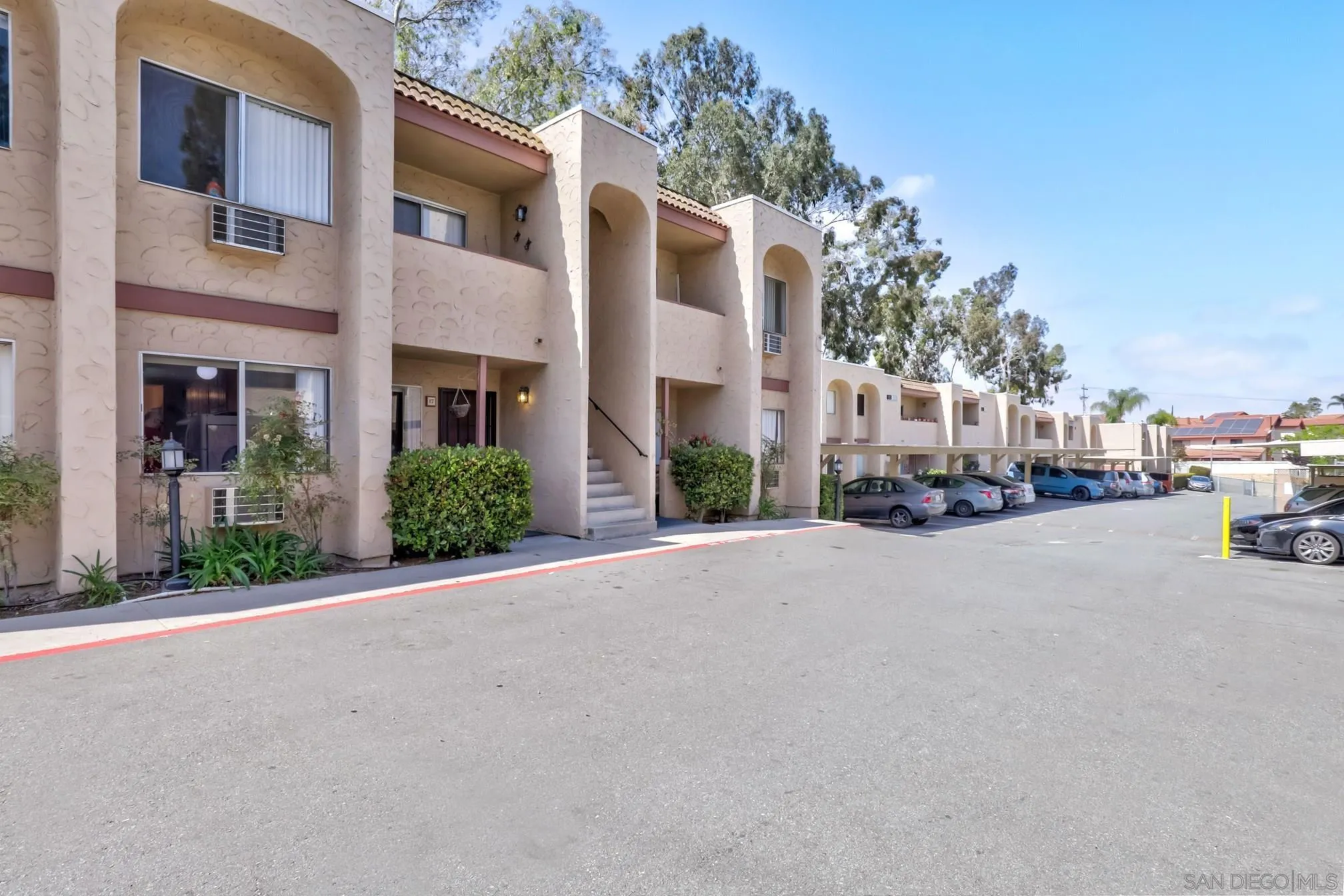 3557 Kenora Drive, Unit 17 Spring Valley, CA 91977 - Photo 7 of 8 a city street lined with buildings and cars parked on the roadside
