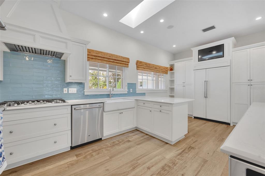 700 Pinetree Road Winter Park, FL 32789 - Photo 17 of 58 a kitchen with granite countertop white cabinets and white appliances