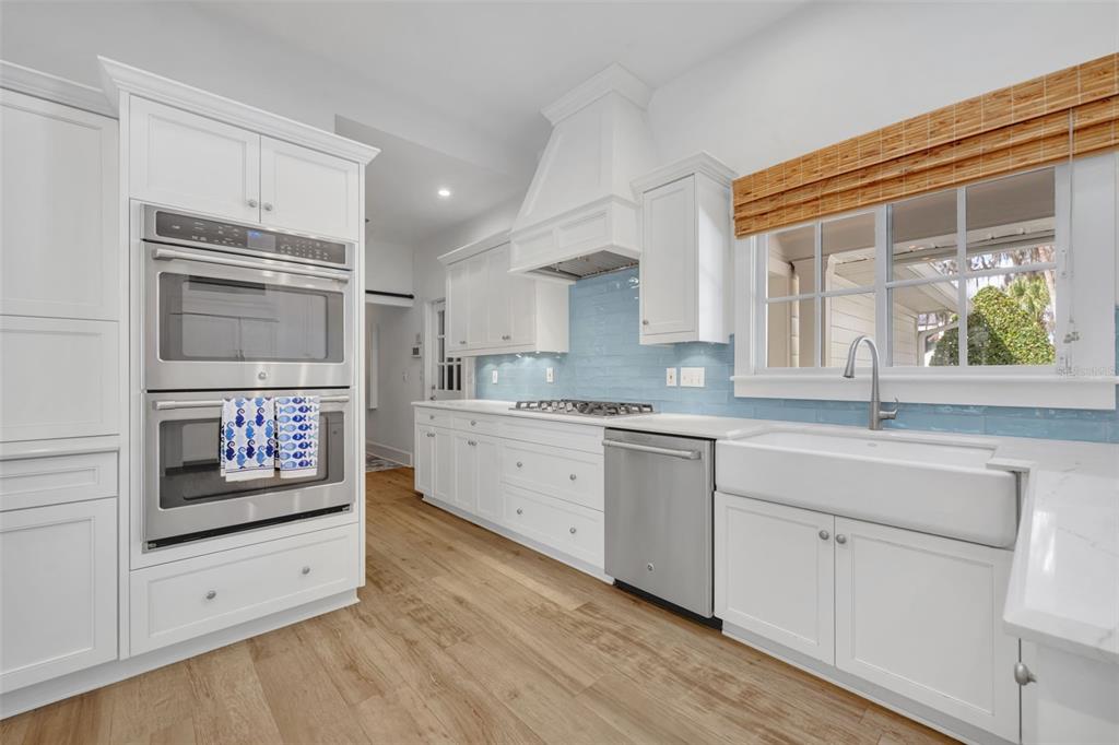 700 Pinetree Road Winter Park, FL 32789 - Photo 19 of 58 a kitchen with stainless steel appliances white cabinets and a window