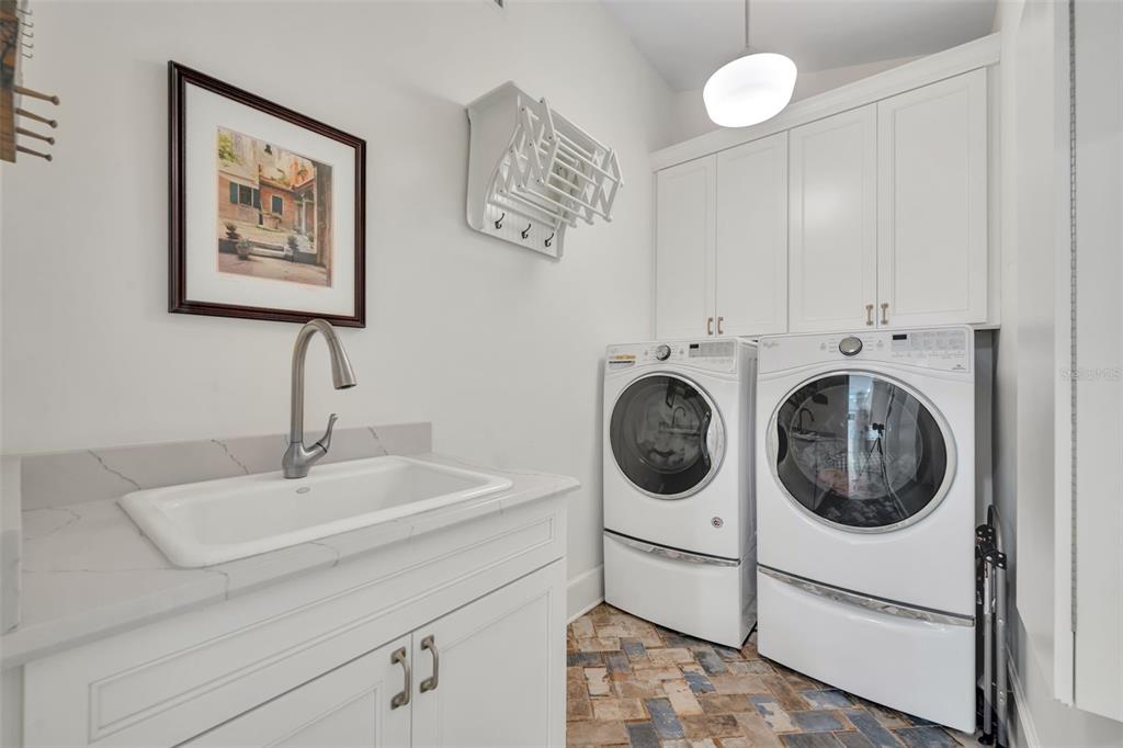 700 Pinetree Road Winter Park, FL 32789 - Photo 20 of 58 a bathroom with a sink and a washer dryer