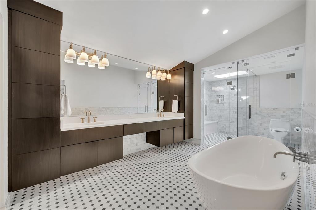 700 Pinetree Road Winter Park, FL 32789 - Photo 29 of 58 a spacious bathroom with a bathtub shower sink mirror and toilet