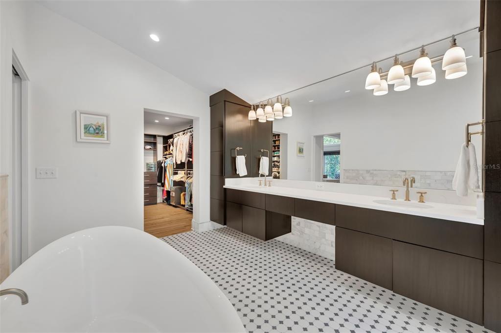 700 Pinetree Road Winter Park, FL 32789 - Photo 31 of 58 a spacious bathroom with a sink a large mirror and a shower