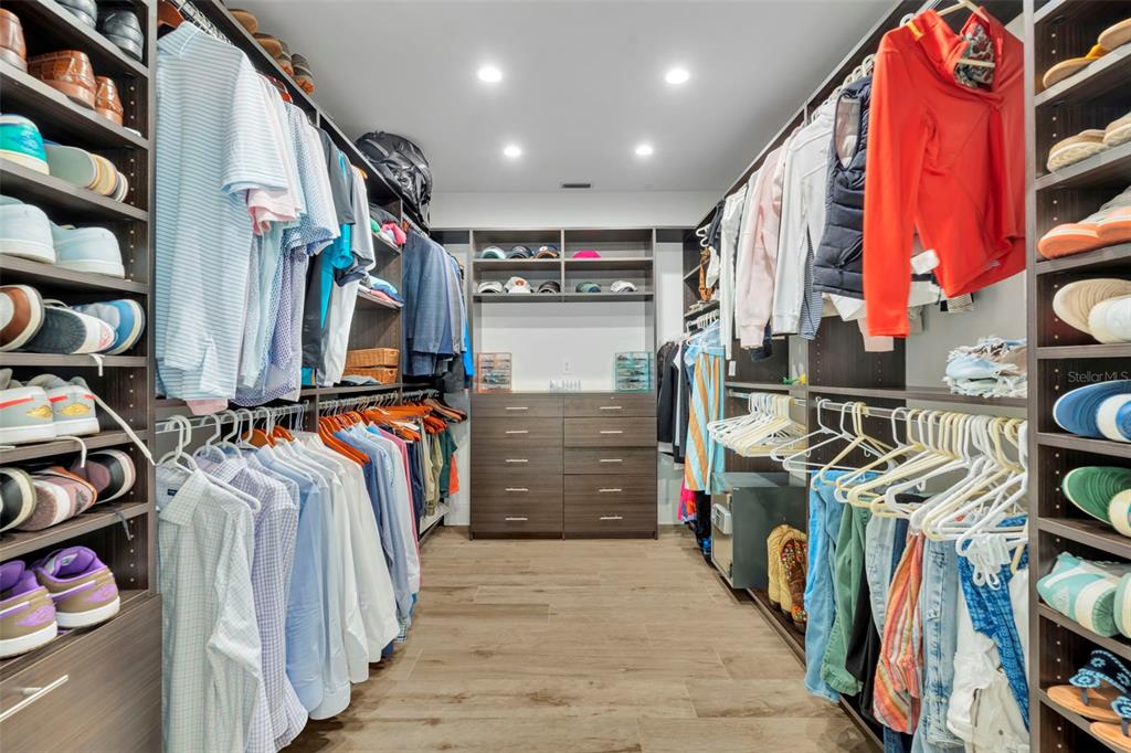 700 Pinetree Road Winter Park, FL 32789 - Photo 33 of 58 a view of walk in closet with clothes and shoes