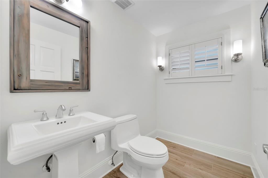 700 Pinetree Road Winter Park, FL 32789 - Photo 34 of 58 a bathroom with a toilet sink and mirror